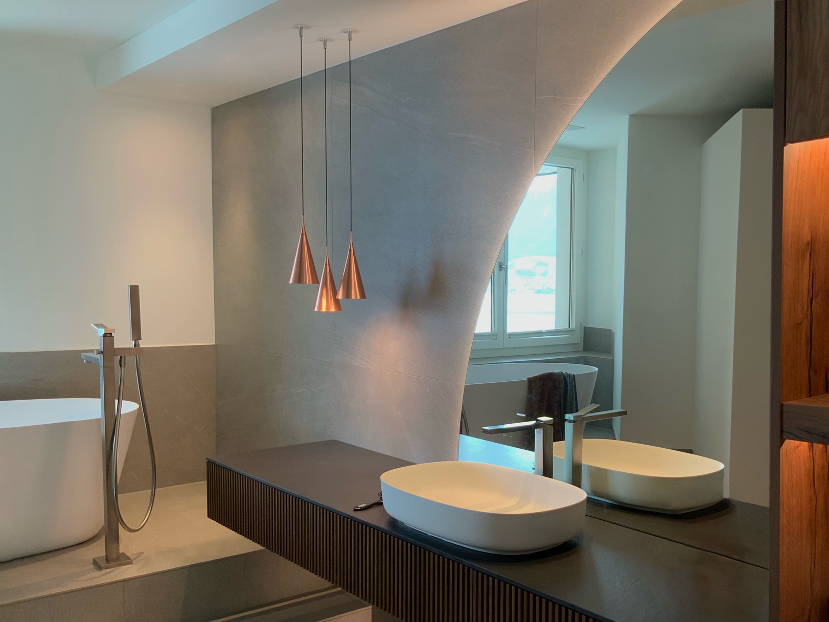 origo-cone-luxury-bathroom-manooi-design Origo Cone is hanging above a sink in a contemporary bathroom.
